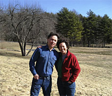 man and woman standing together in field